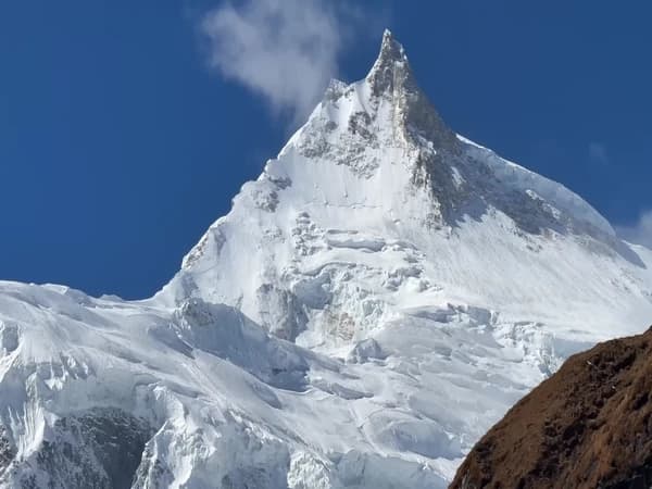 Close-up view of Mount Manaslu showcasing its snow-covered summit during the Manaslu Circuit Trek in Nepal with Thrill Himalaya Treks.